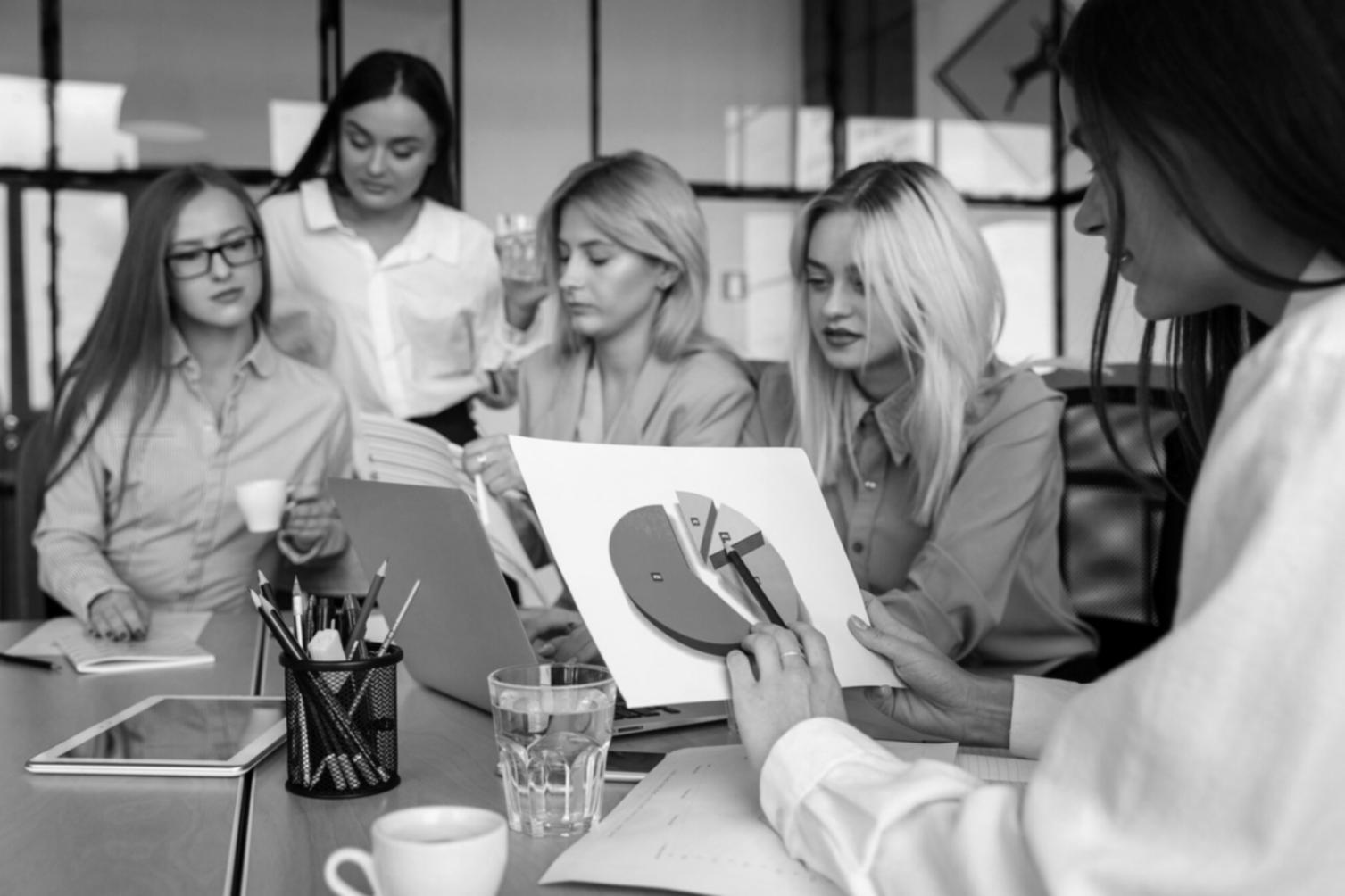 Business professionals reviewing financial charts and planning documents during a collaborative workshop session
